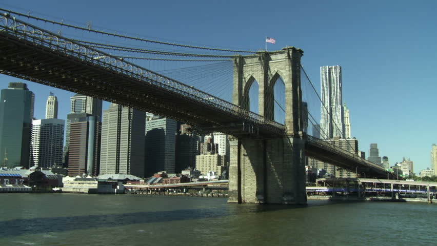 Going under the Brooklyn Bridge and revealing the New York City skyline seen
