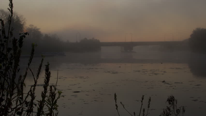 Sunrise over a mist-covered Huron River in Michigan, USA. Timelapse.