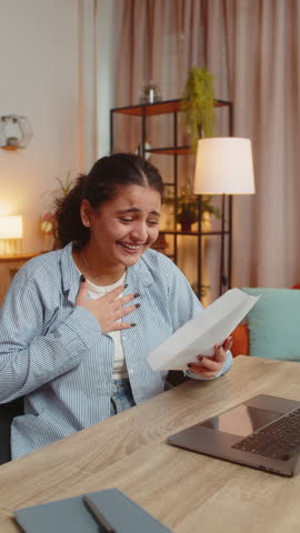 Indian woman open envelope letter reading it. Career growth advance promotion bank loan approve, successful admission to monetary award, long-awaited invitation great news lottery game win. Vertical.
