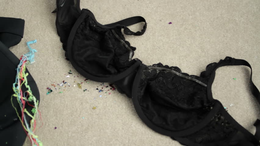 Panning across clothes shed after a big night reveals a tuxedo and a bra.