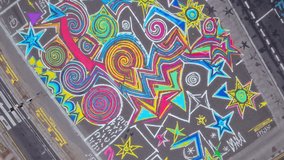 Aerial perspective shows stunning street art with spirals, stars, and geometric shapes that captivate the imagination - Powered by Shutterstock - Get 15% off with code: PIKWIZARD15