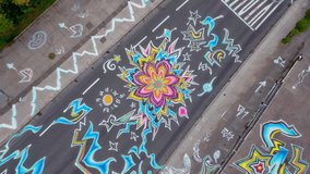 An aerial view reveals stunning street art with bright colors and intricate patterns adorning the pavement - Powered by Shutterstock - Get 15% off with code: PIKWIZARD15