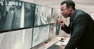 Black man, security guard and screen with radio for surveillance alert or building safety. Male person, CCTV operator or mall cop with speaker or display for communication, footage or observation - Powered by Shutterstock - Get 15% off with code: PIKWIZARD15