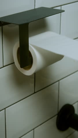 Toilet paper being used and running out symbolizing economy and consumption vertical video
