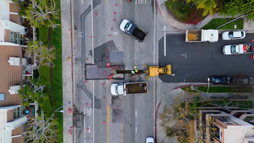 Static Aerial Shot of Road Construction Crew Working in an Urban Area - Powered by Shutterstock - Get 15% off with code: PIKWIZARD15