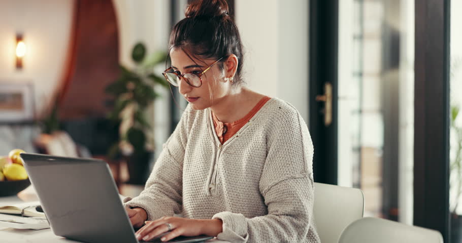 Laptop, typing and woman in home office for remote work, research or author writing story for article. Computer, serious freelancer or reading online, proofreading or creative editing for publishing