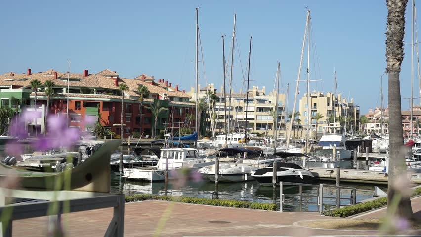 Boats in the port of Sotogrande and flowers on the side, Cadiz, Spain. 