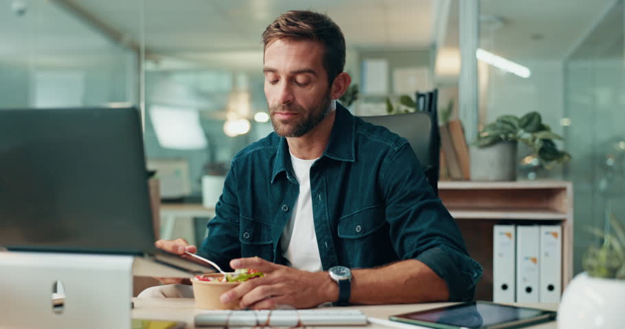 Man, eating and reading proposal with laptop, salad and lunch with networking in office. Business person, email and planning review for project management, report deadline and diet snack in home