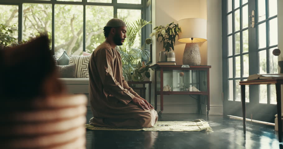 Muslim, faith and man with praying on mat for spiritual meditation, islamic worship or gratitude. Ramadan, person and salah in living room for fasting tradition, praise to Allah or religious blessing