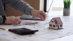 Designer or designer designs a house model - Powered by Shutterstock - Get 15% off with code: PIKWIZARD15