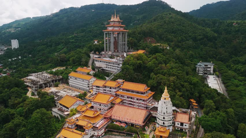 Aerial view of Penang kek lok si temple showcases the intricate architecture of pagoda guan yin, main temple buildings, and surrounding lush greenery, Malaysia. Translation: Temple of Supreme Bliss