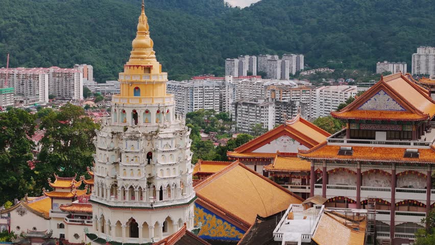 Kek lok si temple pagoda stands tall, showcasing its vibrant colors against George Town, Penang urban backdrop and lush greenery. Malaysia. Translation: Temple of Supreme Bliss
