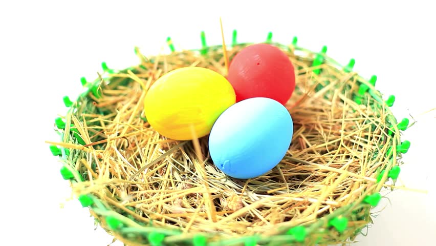 A beautiful close-up of Easter eggs placed in a natural straw nest, representing joy and festivity. Ideal for holiday marketing, greeting cards, and festive promotions.