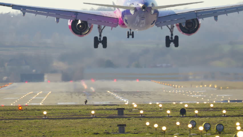Passenger plane makes a smooth landing on the runway at a busy airport during a sunny day of travel and tourism adventures