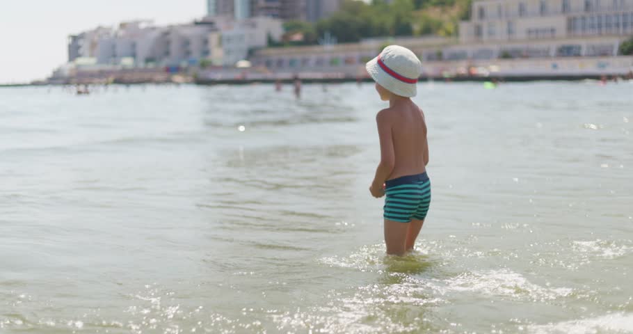 Child Enjoying Summer Beach Waves 