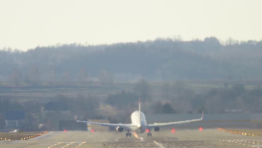 Passenger plane departs from runway, embarking on a journey through the skies amid scenic landscapes