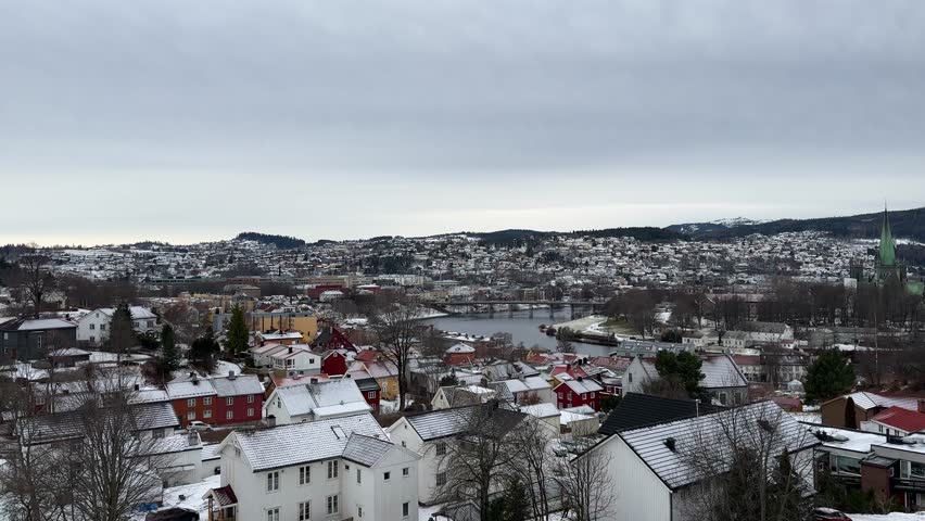 Bird eye aerial view of Trondheim Nidaros city during winter season snow covered Norwegian houses cold frozen urban landscape of Scandinavia
