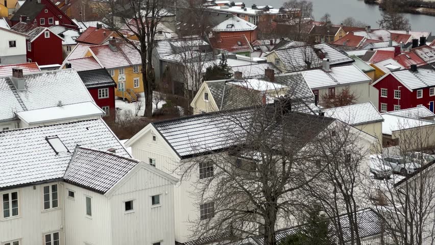 Bird eye aerial view of Trondheim Nidaros city during winter season snow covered Norwegian houses cold frozen urban landscape of Scandinavia