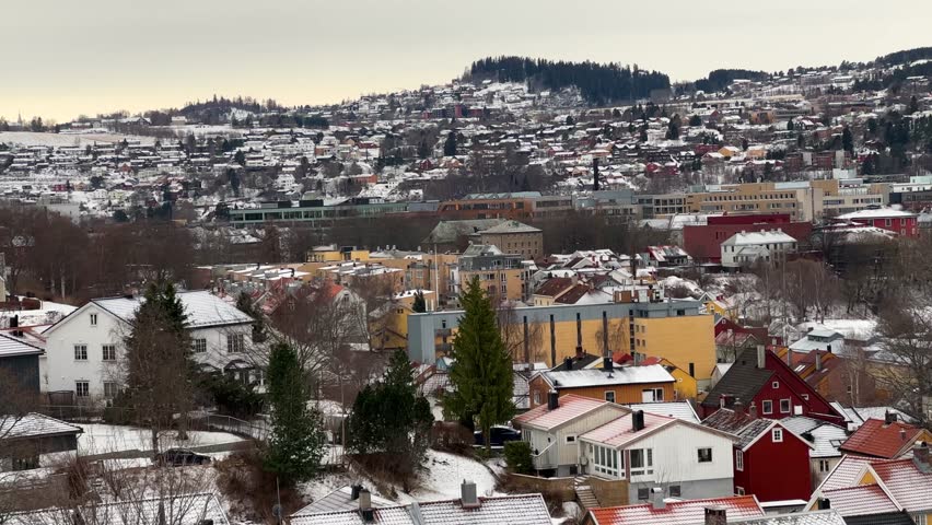 Bird eye aerial view of Trondheim Nidaros city during winter season snow covered Norwegian houses cold frozen urban landscape of Scandinavia