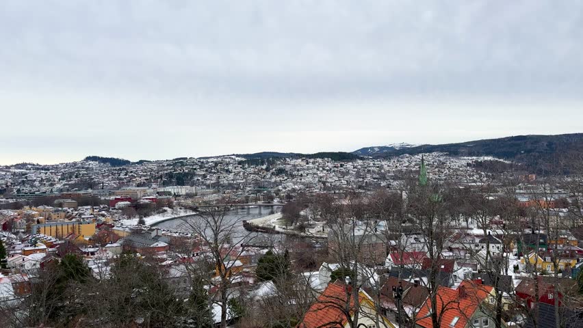Bird eye aerial view of Trondheim Nidaros city during winter season snow covered Norwegian houses cold frozen urban landscape of Scandinavia