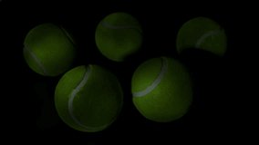 Vibrant Green Tennis Balls Floating in Dramatic Dark Minimalist Composition - Powered by Shutterstock - Get 15% off with code: PIKWIZARD15
