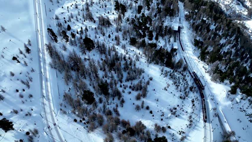 Moving shot from Gornergrat train departing station with nature covered in snow. Perfect for travel, adventure, and scenic winter landscape