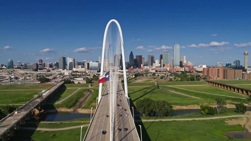 Margaret Hunt Hill Bridge spanning the Trinity River with downtown Dallas skyline in background