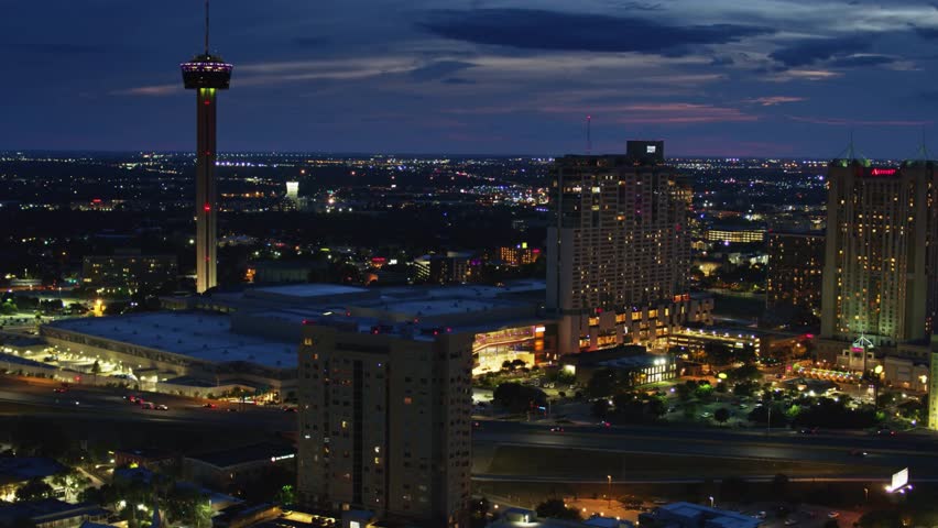 San Antonio skyline at night featuring the Tower of the Americas with glowing city lights