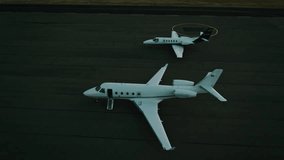 Private jets parked on the tarmac at sunset with golden sky in the background - Powered by Shutterstock - Get 15% off with code: PIKWIZARD15