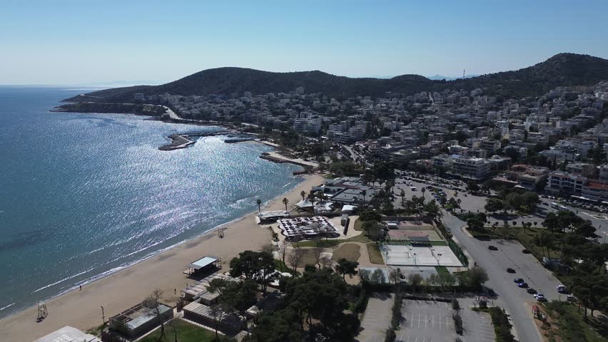 Vari, Attica, Greece - March 6th, 2025 - aerial footage of the town, coastline, beaches, parks and mountains