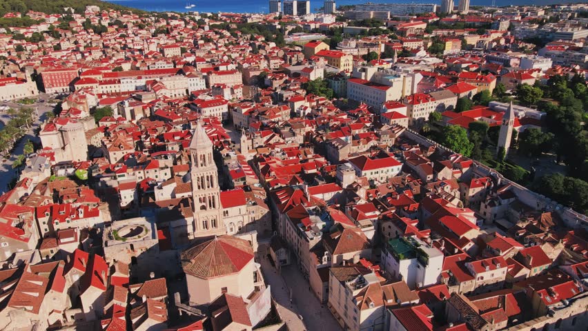 Aerial view of Split, Croatia with historic old town, Diocletians Palace and narrow streets and harbor near sea landscape in background. Adriatic coastline in coastal touristic city on summer day