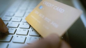 Entering credit card details on a laptop keyboard for online payment, financial transaction, cybersecurity risks, digital banking security, fraud prevention - Powered by Shutterstock - Get 15% off with code: PIKWIZARD15