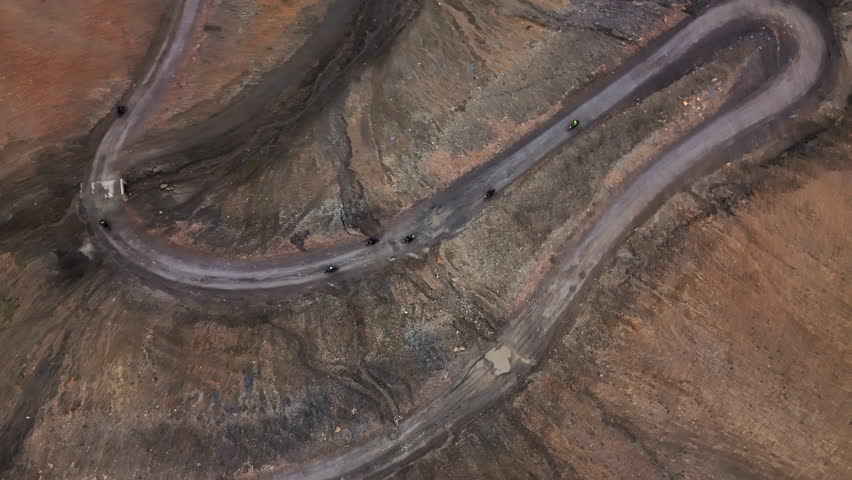 Bikers ride along a winding mountain road