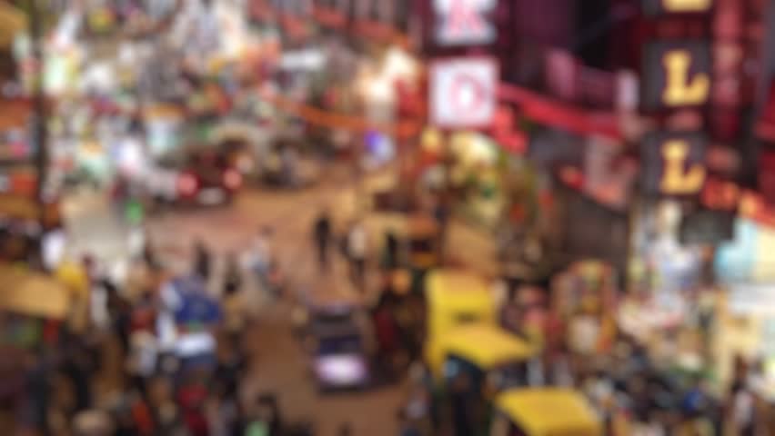 Blurred top angle view of the Main Bazar road with busy traffic at late evening in Delhi, India.