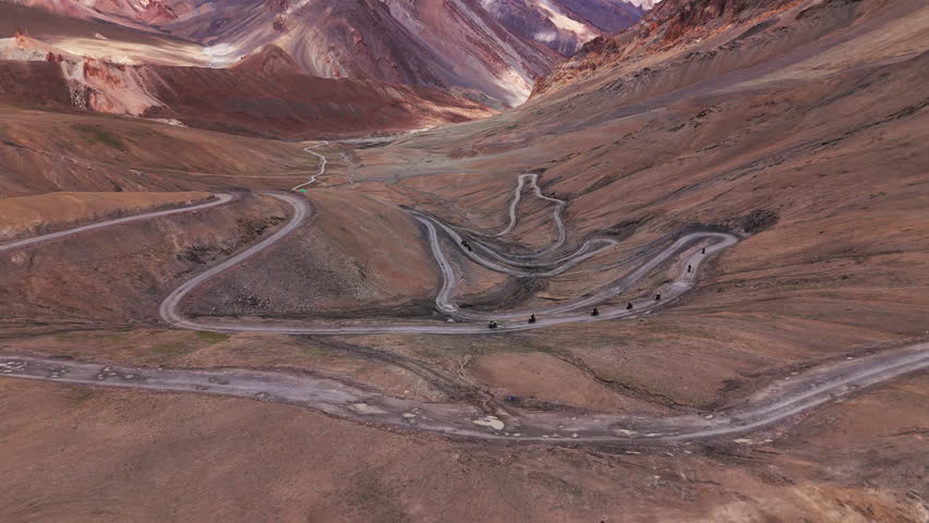 Bikers ride along a winding mountain road