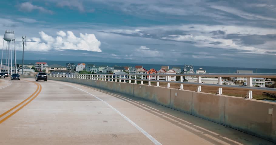 Scenic Drive on Surf City Bridge, NC, Toward Coastal Beachfront – Travel and Road Trip Concept. Driving to the seaside. summer travel