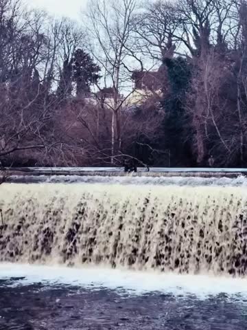 A serene river flowing over a weir