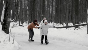 Young family with their teenage son are skating on an ice rink in middle of snowy forest. child is enjoying himself, laughing and having fun with his parents. - Powered by Shutterstock - Get 15% off with code: PIKWIZARD15