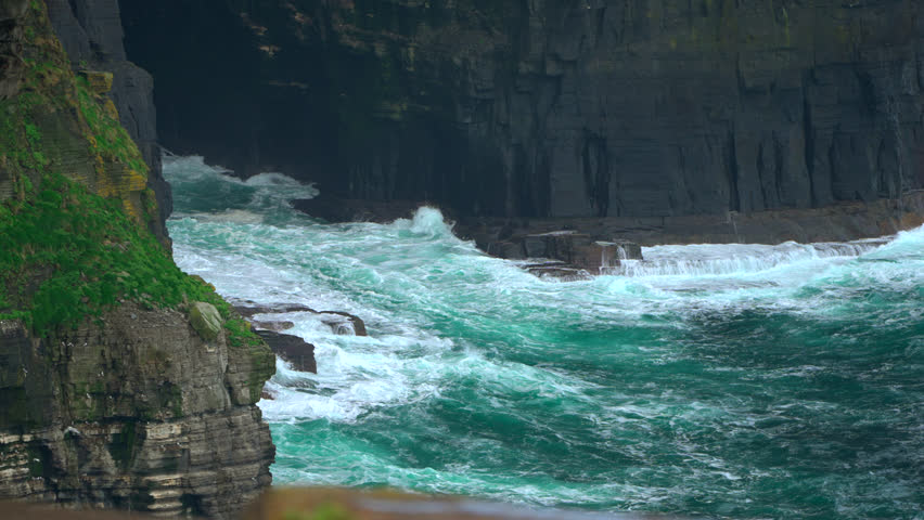 Waves relentlessly pound the Cliffs of Moher, carving the towering rock face over time. The dramatic clash of sea and stone highlights the raw, natural power of Ireland’s Atlantic coastline.
