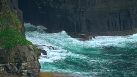 Waves relentlessly pound the Cliffs of Moher, carving the towering rock face over time. The dramatic clash of sea and stone highlights the raw, natural power of Ireland’s Atlantic coastline. - Powered by Shutterstock - Get 15% off with code: PIKWIZARD15