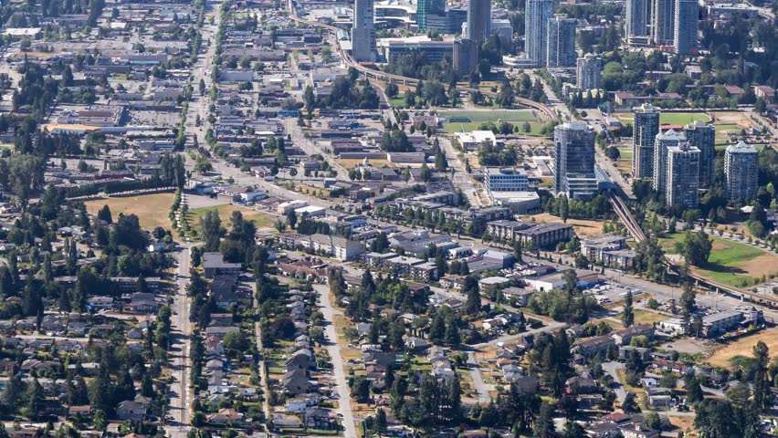 Aerial view of Surrey, BC, Canada, showcasing its diverse cityscape, residential areas, and green spaces. British Columbia, Canada.