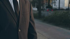 Businessman raises hand and looks at the smartwatch on it. Businessman is typing message on the smartwatch.  Modern gadgets and people concept. Modern communication. Close up, slow motion footage. - Powered by Shutterstock - Get 15% off with code: PIKWIZARD15