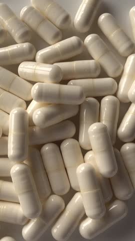 Medicines in White capsules vertical view