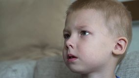 Blond preschooler watching television with intense concentration, expressing curiosity and wonder while absorbing engaging content through digital media - Powered by Shutterstock - Get 15% off with code: PIKWIZARD15