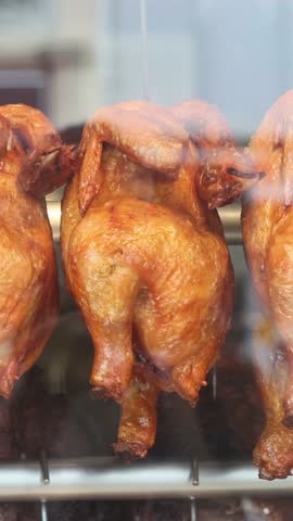 Hanging roasted chickens in a shop