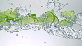 Super Slow Motion of Lime Slices Flying with Splashing Water at 1000fps on White Background. - Powered by Shutterstock - Get 15% off with code: PIKWIZARD15