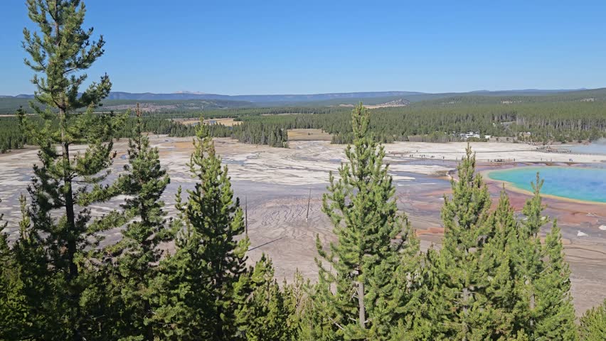Colourful Grand Prismatic Spring. Largest hot spring in the United States. Motion of people and cars in the background. Yellowstone National Park, Wyoming, United States
