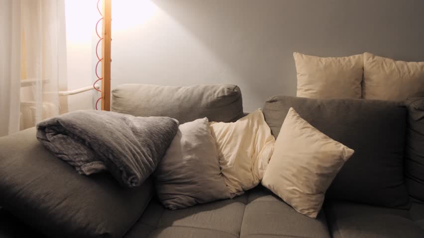 Woman relaxing on a sofa, covered with a blanket, with an e-reader nearby - Powered by Shutterstock - Get 15% off with code: PIKWIZARD15