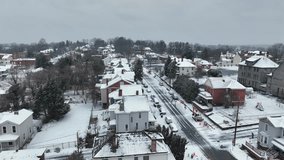 Parking Excavator on street of american town in winter snow. Aerial Orbit wide shot. American neighborhood during winter snow and flying flurries. Dark grey sky in Virginia, USA. - Powered by Shutterstock - Get 15% off with code: PIKWIZARD15