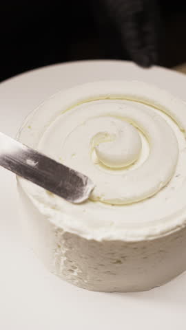 Top view of pastry chef making cake by use spatula to putting cream